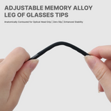 Adjustable memory alloy leg of glasses tips being held by a hand on a light gray background.