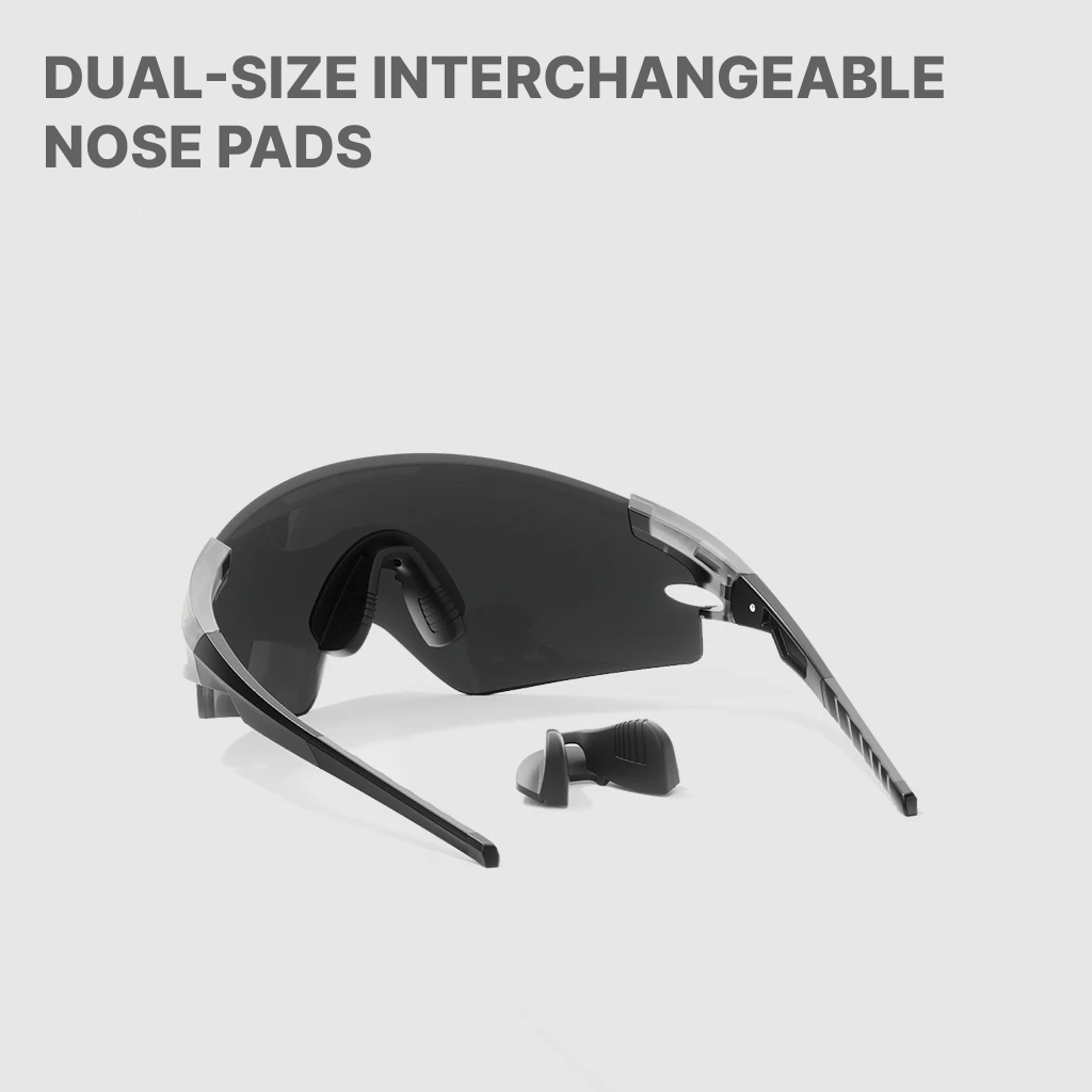 Black sunglasses with interchangeable nose pads on a light gray background