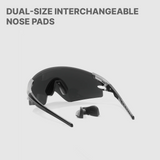 Black sunglasses with interchangeable nose pads on a light gray background