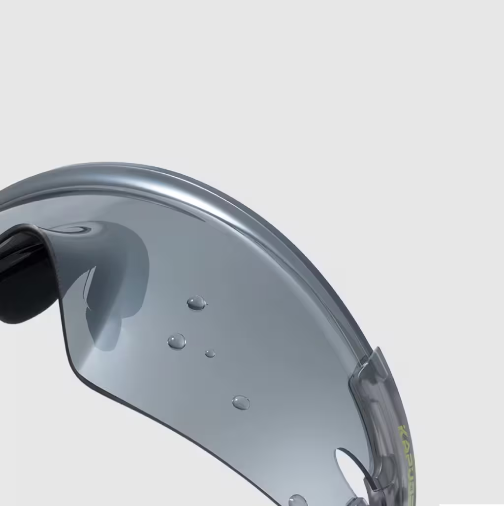 Close-up of a gray helmet visor with water droplets on a light gray background