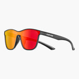 Sunglasses with red lenses and black frame on a white background, featuring the UNBOUND brand.