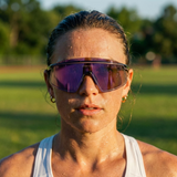 Person wearing reflective sunglasses outdoors on a sunny day