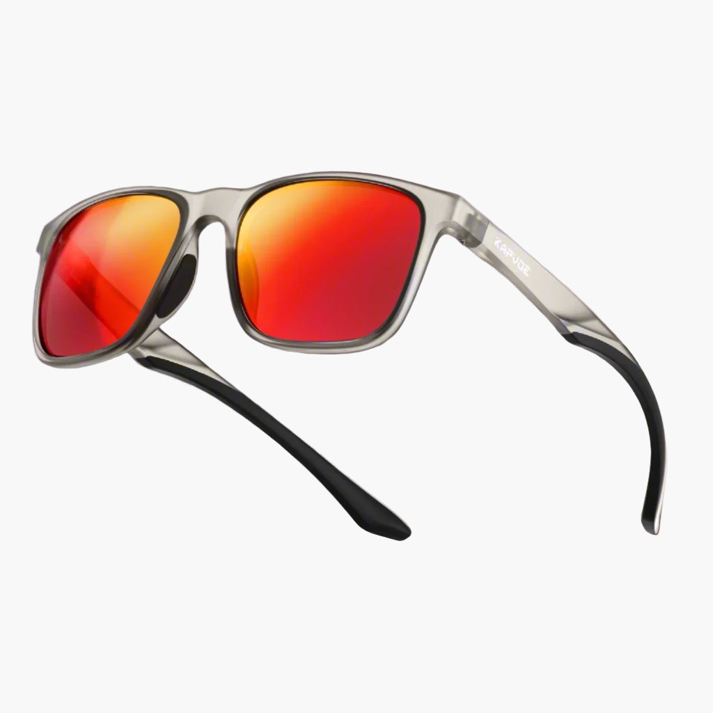 Sports sunglasses with red lenses and black arms on a dark red background, featuring the brand 'UNBOUND'.