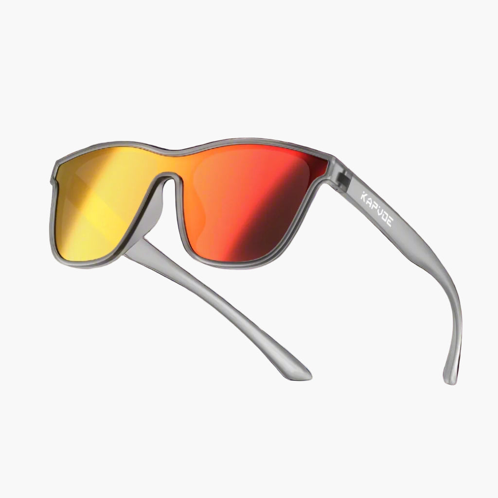 Sunglasses with yellow and red lenses on a lighting background, featuring the brand 'UNBOUND'.