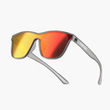 Sunglasses with yellow and red lenses on a lighting background, featuring the brand 'UNBOUND'.