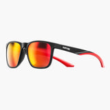 Sunglasses with red lenses and black frame on a white background, featuring the UNBOUND brand.