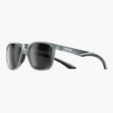 Sunglasses with gray frame and dark lenses on a white background, featuring the UNBOUND brand.